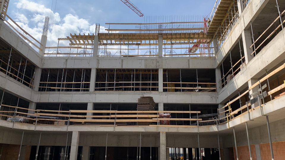 Dělníci staví nadzemní podlaží centrálního urgentního příjmu Pardubické nemocnice