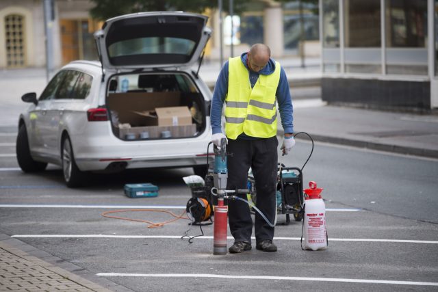 Pracovník osazuje parkovací senzory v Pernerově ulici. Senzory budou základem inteligentního parkovacího systému | foto: Josef Vostárek,  ČTK